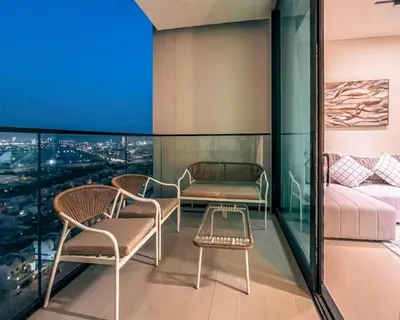 a room with chairs and a couch and a table at Modern Place - Binghatti Azure 1244 in Dubai