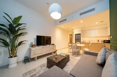 a living room with a couch and a table and a kitchen at Burj Royale Luxury Burj Khalifa dubai mall downtown city centre in Dubai