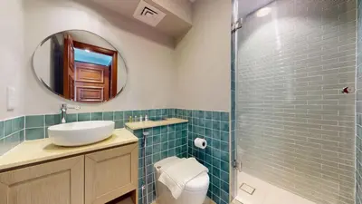 a bathroom with a toilet and a sink and a mirror at Golden Mile - Serene Two Bedroom on the Palm in Dubai