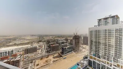 an aerial view of a city with tall buildings at The Crest A - Premium Two Bedroom High-Rise Escape in Dubai