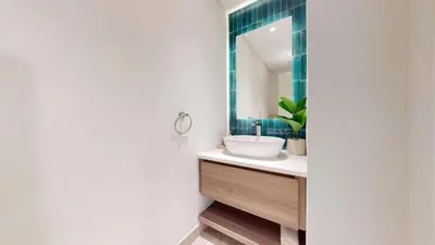 a bathroom with a sink and a mirror at Al Dabas - One Bed with Beach Access and Sea View in Dubai
