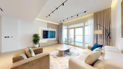 a living room with two couches and a tv at Al Dabas - One Bed with Beach Access and Sea View in Dubai