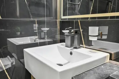 a bathroom with a white sink and two sinks at Golden Stays - Binghatti Crescent I Cozy 1BR Retreat I Pool & Gym I JVC Dubai in Dubai