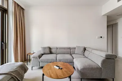 a living room with a couch and a table at Creek crescent high floor in Dubai