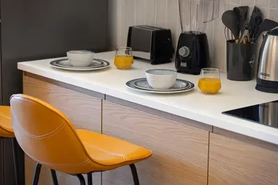 a kitchen counter with two glasses of orange juice at Lux 3 BR Sea View Condo with Pool & Sauna In Marina in Dubai