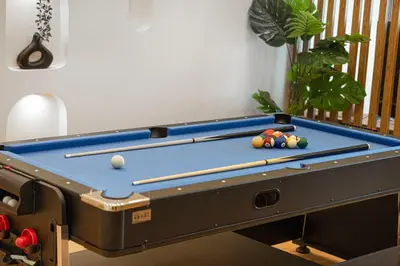 a pool table with billiard balls on top of it at Lux 3 BR Sea View Condo with Pool & Sauna In Marina in Dubai