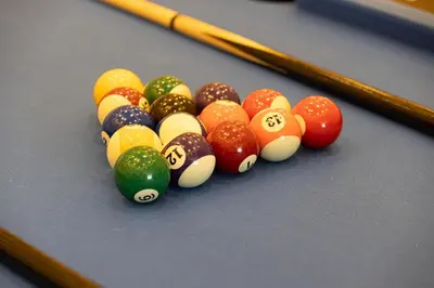 a group of billiard balls on a pool table at Lux 3 BR Sea View Condo with Pool & Sauna In Marina in Dubai