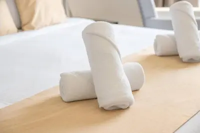 a group of white towels on a bed at Jbr shams apartment in Dubai