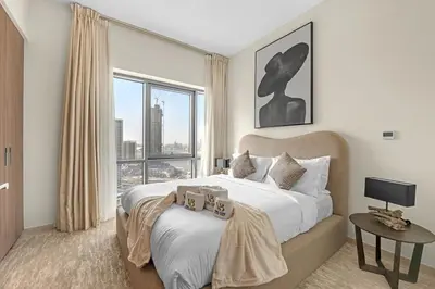 a bedroom with a large bed and a large window at Guest Favorite - Elegant & Stylish 2BR Stay at Vida Creek Harbour in Dubai