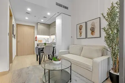 a living room with a couch and a table at Chic Urban Studio in Dubai in Dubai