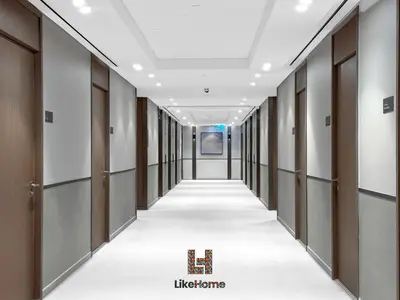 an empty corridor in a building with doors and ceilings at Next to Burj Khalifa & Dubai Mall Grande Signature 2BR , Enjoy Dubai Skyline from Balcony Like Home in Dubai