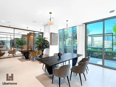 a dining room with tables and chairs and large windows at Next to Burj Khalifa & Dubai Mall Grande Signature 2BR , Enjoy Dubai Skyline from Balcony Like Home in Dubai