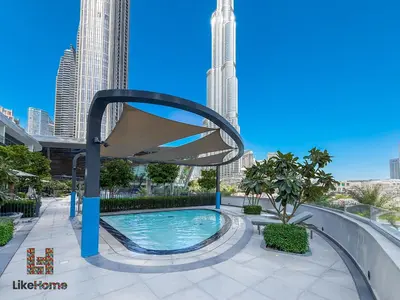 a pool in the middle of a city with tall buildings at Next to Burj Khalifa & Dubai Mall Grande Signature 2BR , Enjoy Dubai Skyline from Balcony Like Home in Dubai