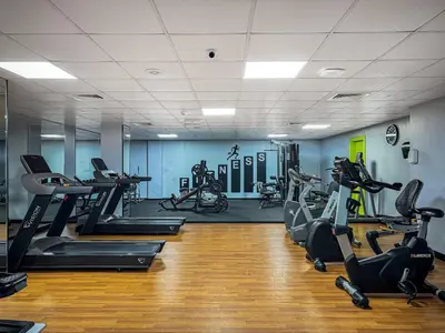 a gym with several treadmills and exercise bikes at Chic 1BR with City Views Near Marina & Metro in Dubai
