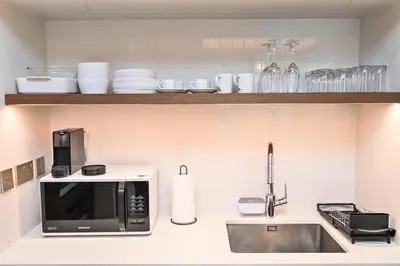 a kitchen with a microwave and a sink at Beach Serenity, Modern 1BR in Dubai, Palace Beach Residences, Emaar Beachfront in Dubai
