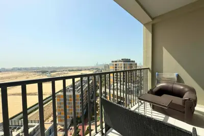 a balcony with a view of a city at Amazing 2BR Peaceful Views in Midtown Near Sports City in Dubai