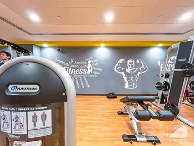 a gym with a weight machine in a room at Amazing 2BR Peaceful Views in Midtown Near Sports City in Dubai