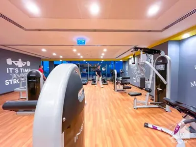 a gym with treadmills and machines in a room at Amazing 2BR Peaceful Views in Midtown Near Sports City in Dubai