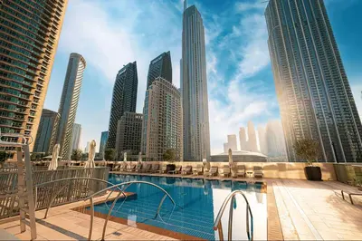 a view of a city skyline with a swimming pool at Vogue Downtown Forte near Dubai Mall and Burj Khalifa, Two-Bedroom Apartment with Balcony and City View, full access to all amenities in Dubai