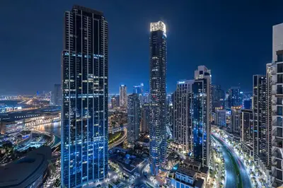 a city skyline at night with tall buildings at Vogue Downtown Forte near Dubai Mall and Burj Khalifa, Two-Bedroom Apartment with Balcony and City View, full access to all amenities in Dubai
