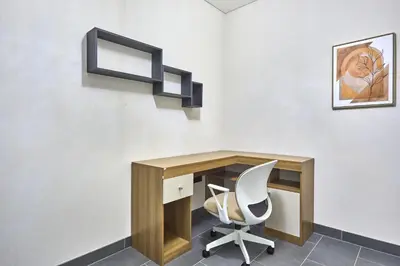 an office with a desk and a white chair at STAY BY LATINEM Luxury 1BR and Study Holiday Home CC 2808 Near Downtown in Dubai
