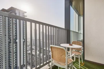 a balcony with a table and chairs and a view of a city at STAY BY LATINEM Luxury 1BR and Study Holiday Home CC 2808 Near Downtown in Dubai