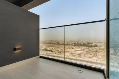 an empty room with a large window looking out at the desert at VayK - Brand New and Bright 1BR in JVC in Dubai
