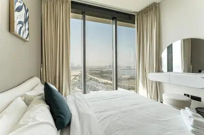 a bedroom with a bed and a large window at HAVN - 2 Bedroom at The Crest, Dubai Skyline Views in Dubai