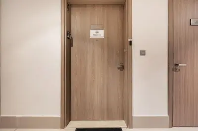 a wooden door with a sign on it at Stylish Studio Apartment in Azizi Riviera One in Dubai
