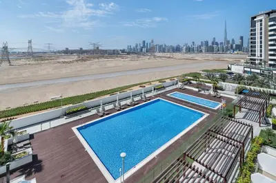 an overhead view of a swimming pool next to a beach at Stylish Studio Apartment in Azizi Riviera One in Dubai