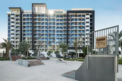 a skate park in front of a large building at Stylish Studio Apartment in Azizi Riviera One in Dubai