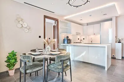 a kitchen and dining room with a table and chairs at STAY BY LATINEM Luxury 2BR Holiday Home CC 1014 Near Burj Khalifa in Dubai