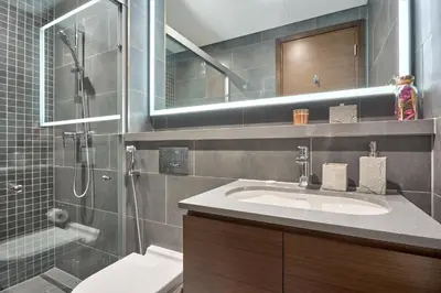 a bathroom with a sink and a shower at STAY BY LATINEM Luxury 2BR Holiday Home CC 1014 Near Burj Khalifa in Dubai