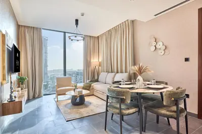 a living room with a table and a couch at STAY BY LATINEM Luxury 2BR Holiday Home CC 1014 Near Burj Khalifa in Dubai