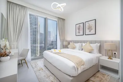 a white bedroom with a large bed and a large window at Vogue Downtown Forte near Dubai Mall and Burj Khalifa, Two-Bedroom Apartment with Balcony and City View, full access to all amenities in Dubai
