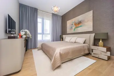 a bedroom with a bed and a flat screen tv at NEU Sea and Burj View Port de La Mer in Dubai