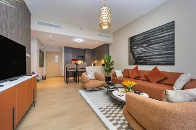 a living room with a couch and a tv at NEU Sea and Burj View Port de La Mer in Dubai