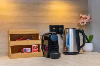 a coffeemaker sitting on a counter next to a coffee maker at NEU Sea and Burj View Port de La Mer in Dubai