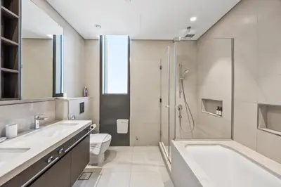 a bathroom with a shower and a sink and a toilet at 2BR Apt Direct Dubai Mall Access Burj View in Dubai