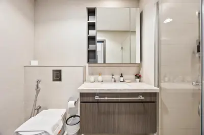 a bathroom with a sink and a toilet and a mirror at 2BR Apt Direct Dubai Mall Access Burj View in Dubai
