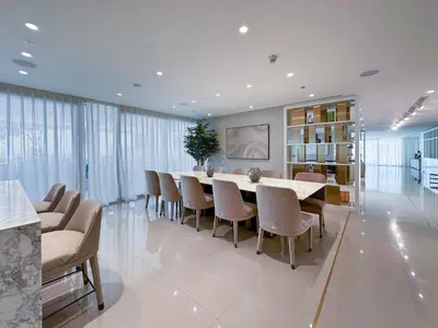 a dining room with a long table and chairs at Chic 2 bedroom w Sunset and Palm Jumeirah Views in Dubai