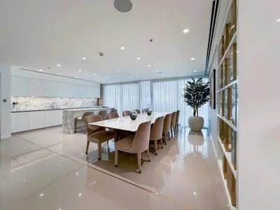 a dining room with a table and chairs at Chic 2 bedroom w Sunset and Palm Jumeirah Views in Dubai