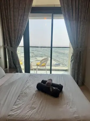 a bed in a room with a large window at Samani vacation homes 2217 in Dubai