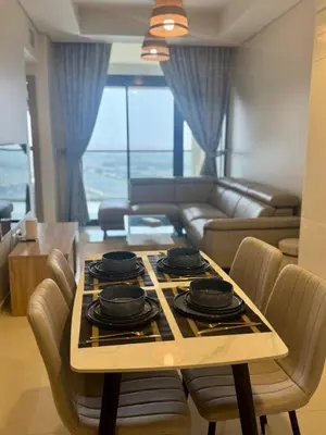 a living room with a table with a stove top at Samani vacation homes 2217 in Dubai