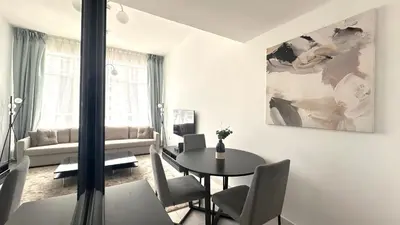 a white living room with a table and chairs at Marine View Tower aparthotel in Dubai