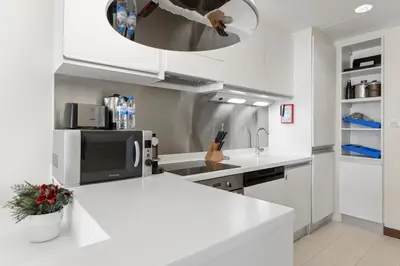 a kitchen with a white counter top and a sink at Abi Holiday Homes - Studio & 1BR Dubai Mall Fashion Avenue Residences in Dubai