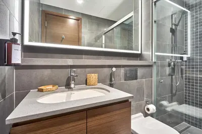 a bathroom with a sink and a glass shower at STAY BY LATINEM Luxury 1BR Holiday Home CB 2701 Near Burj Khalifa in Dubai