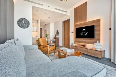 a living room with a couch and a tv at STAY BY LATINEM Luxury 1BR Holiday Home CB 2701 Near Burj Khalifa in Dubai