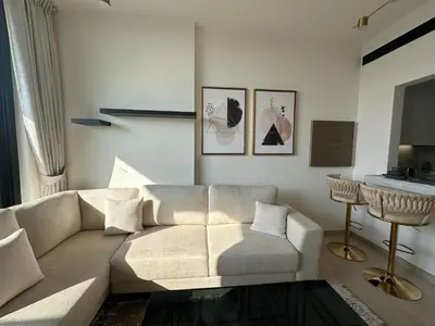 a living room with a couch and a table at Stylish One Bedroom Apartment at Binghatti Crest, JVC Dubai By al sarya Holiday Homes in Dubai