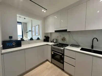 a kitchen with white cabinets and a stove top oven at Stylish One Bedroom Apartment at Binghatti Crest, JVC Dubai By al sarya Holiday Homes in Dubai
